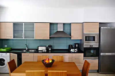 a kitchen with a table with a bowl of fruit on it at Mi Casa és Su Casa in Prainha