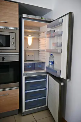 an empty refrigerator with its door open in a kitchen at Mi Casa és Su Casa in Prainha