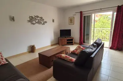 a living room with a couch and a tv at SUNNY Apartment - SAL VILA VERDE - Cabo Verde in Santa Maria