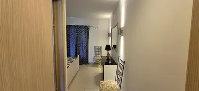 a hallway with a room with a bed and a window at SUNNY Apartment - SAL VILA VERDE - Cabo Verde in Santa Maria
