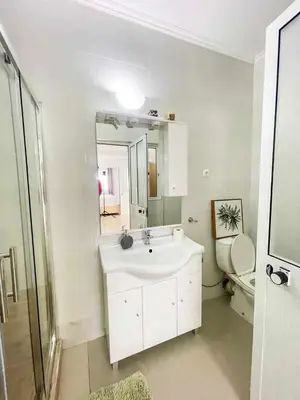 a white bathroom with a sink and a toilet at Zeyden Place Apt 2 in Praia