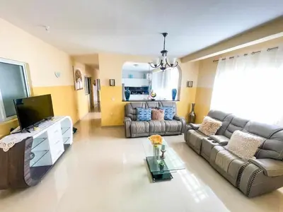 a living room with a couch and a tv at Zeyden Place Apt 2 in Praia