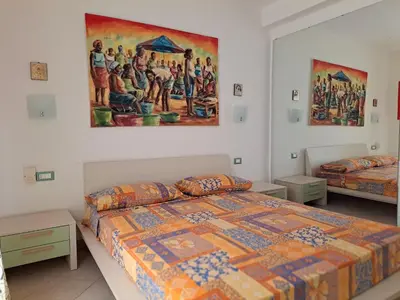 a bedroom with two beds and a painting on the wall at Sal service coquero in Santa Maria