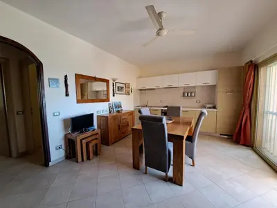 a kitchen and dining room with a table and chairs at Sal service coquero in Santa Maria