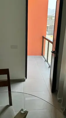 an open door to a room with a balcony at Apartamento moderno I - T1 - Cidade do Porto Novo - Ilha Santo Antão in Porto Novo