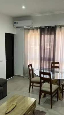 a living room with a dining room table and chairs at Apartamento moderno I - T1 - Cidade do Porto Novo - Ilha Santo Antão in Porto Novo