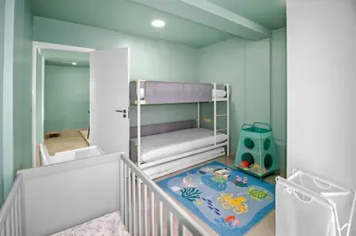 a childs room with a bunk bed and a rug at Sea-view Central Joy! in Mindelo