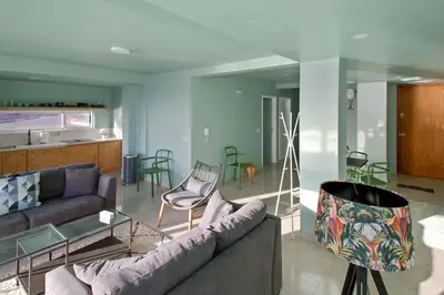 a living room with a couch and a table at Sea-view Central Joy! in Mindelo