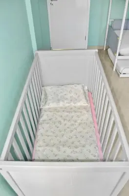 a white crib with a mattress in a room at Sea-view Central Joy! in Mindelo
