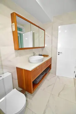 a bathroom with a sink and a toilet and a mirror at Sea-view Central Joy! in Mindelo