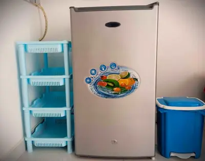a refrigerator with a plate of food on the door at Kaza Papaya - Papaya House in Tarrafal