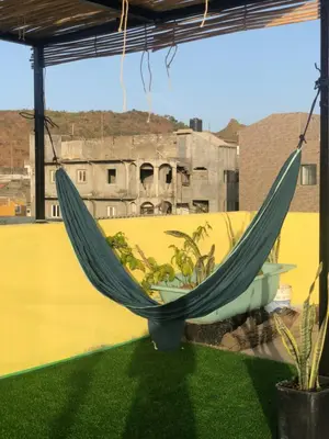 a hammock on a balcony with a view of a building at Simple sunlight apartment - Assomada in Assomada