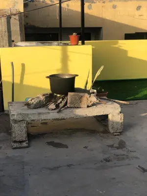 a pot sitting on top of a stone stove at Simple sunlight apartment - Assomada in Assomada