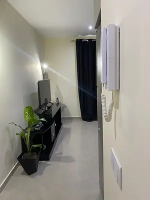 a room with a tv and a phone on the wall at T1 Férias Mindelo in Mindelo