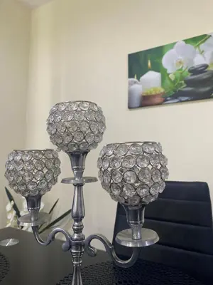 two silver candlesticks sitting on top of a table at T1 Férias Mindelo in Mindelo