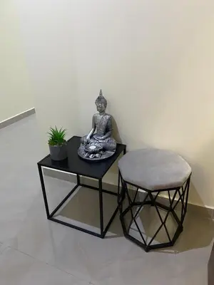 a statue of a woman sitting on a table with a stool at T1 Férias Mindelo in Mindelo