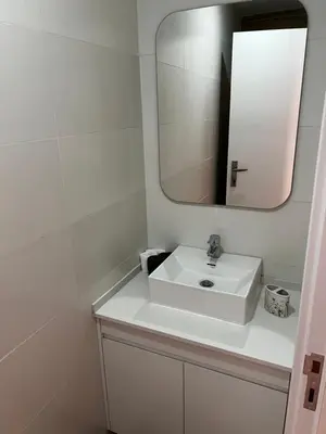 a bathroom with a white sink and a mirror at ROYAL PALMAREJO APPARTAMENTO in Praia