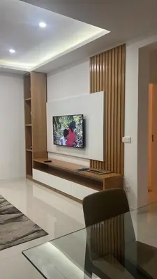 a living room with a tv on a wall at ROYAL PALMAREJO APPARTAMENTO in Praia