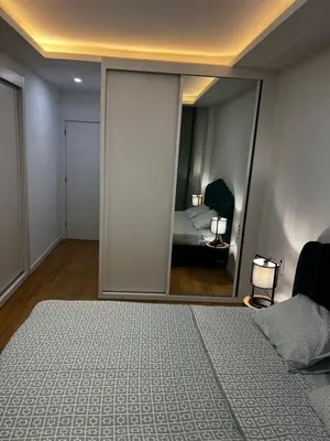 a bedroom with a bed and a large mirror at ROYAL PALMAREJO APPARTAMENTO in Praia