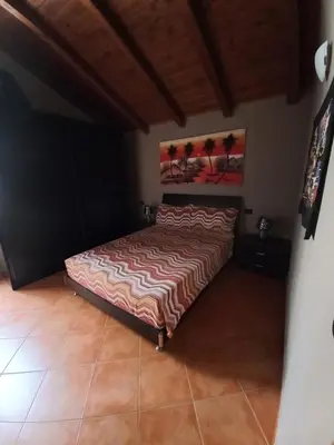a bedroom with a bed in a room at Patio Antigo 218 in Santa Maria