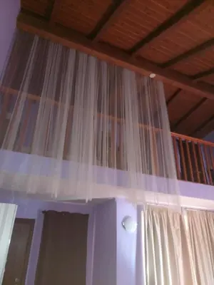 a curtain hanging from a ceiling in a room at Patio Antigo 218 in Santa Maria