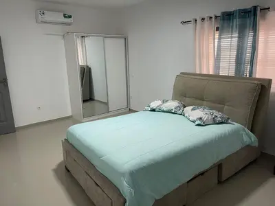 a bed with two pillows in a room with a mirror at Pinto’s in Praia