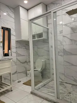 a white bathroom with a toilet and a sink at Pinto’s in Praia