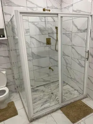 a shower with a glass door in a bathroom at Pinto’s in Praia
