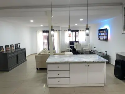a kitchen and living room with a white counter top at Pinto’s in Praia