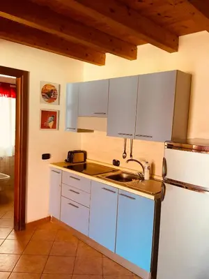 a kitchen with a sink and a refrigerator at Apartment Terrace - front sea view From - May till September in Santa Maria
