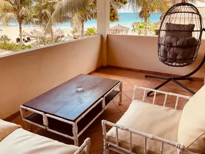 a table and chairs in a room with a view of the beach at Apartment Terrace - front sea view From - May till September in Santa Maria