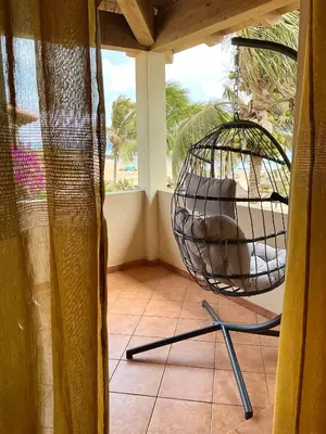 a chair sitting on a porch with a swing at Apartment Terrace - front sea view From - May till September in Santa Maria