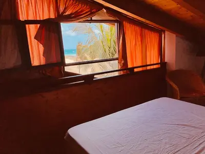 a bedroom with a bed and a window with a view of the beach at Apartment Terrace - front sea view From - May till September in Santa Maria