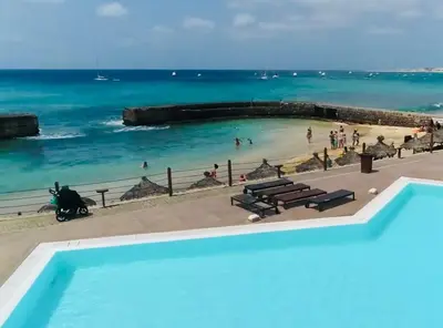 a view of a beach with people in the water at Apartment Terrace - front sea view From - May till September in Santa Maria