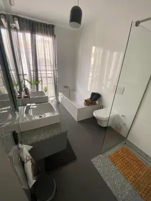 a bathroom with a sink and a toilet and a shower at Morabezahome - Zaza in Mindelo