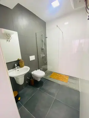 a bathroom with a toilet and a shower and a sink at Morabezahome - Zaza in Mindelo