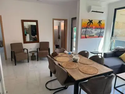a living room with a wooden table and chairs at NEW Luxury Condo - In the heart of Santa Maria in Santa Maria