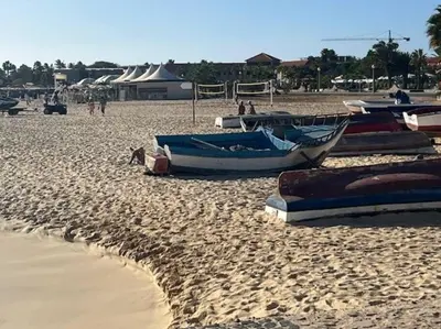 a group of boats sitting on a sandy beach at NEW Luxury Condo - In the heart of Santa Maria in Santa Maria