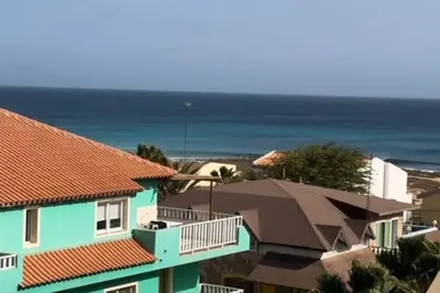 a group of houses with the ocean in the background at NEW Luxury Condo - In the heart of Santa Maria in Santa Maria