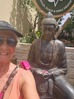 a woman is standing next to a statue at Tortuga beach resort Penthouse apartment for holiday rental in Prainha