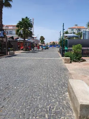 a cobblestone street with palm trees and buildings at Tortuga beach resort Penthouse apartment for holiday rental in Prainha