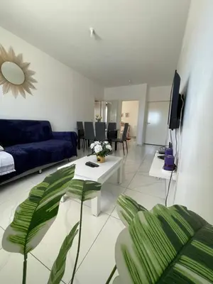a living room with a blue couch and a table at house of happiness in Praia