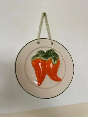 a ceramic ornament of a carrot on a plate at house of happiness in Praia