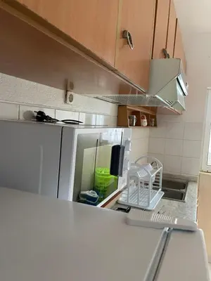 a kitchen with a white refrigerator and a sink at house of happiness in Praia
