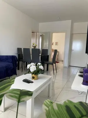 a living room with a couch and a table with flowers on it at house of happiness in Praia