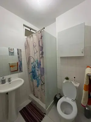 a bathroom with a toilet and a sink at house of happiness in Praia