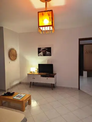 a living room with a television and a table at Apartment Funana Tarrafal in Tarrafal