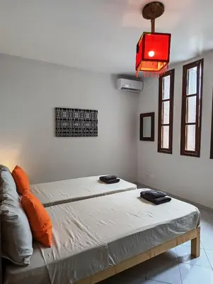 a room with two beds and a red light at Apartment Funana Tarrafal in Tarrafal