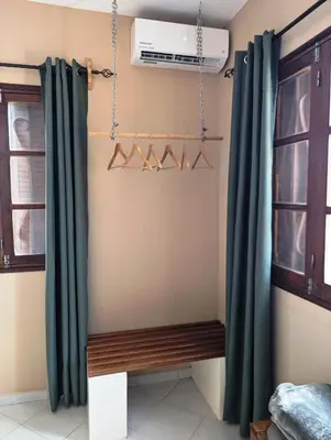 a room with green curtains and a bench at Apartment Funana Tarrafal in Tarrafal