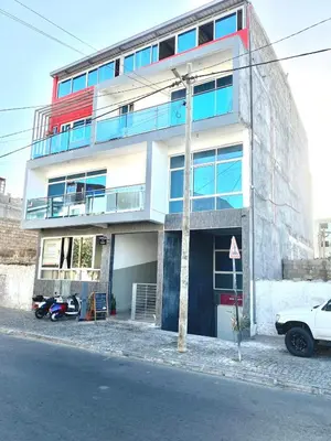 a building with a motorcycle parked in front of it at My Flat 0 in Praia